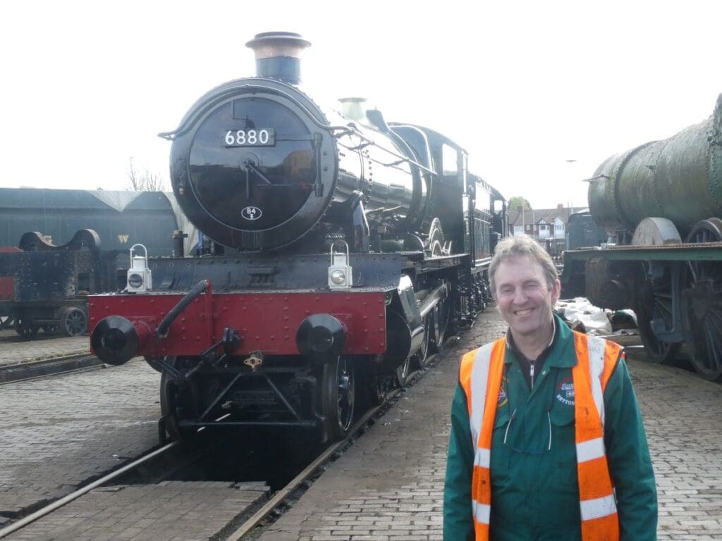 Betton Grange Society Ltd chairman Quentin McGuinnes smiles in front of Great Western Railway's new build steam engine 4-6-0 No. 688 Betton Grange at Tyseley Locomotive Works